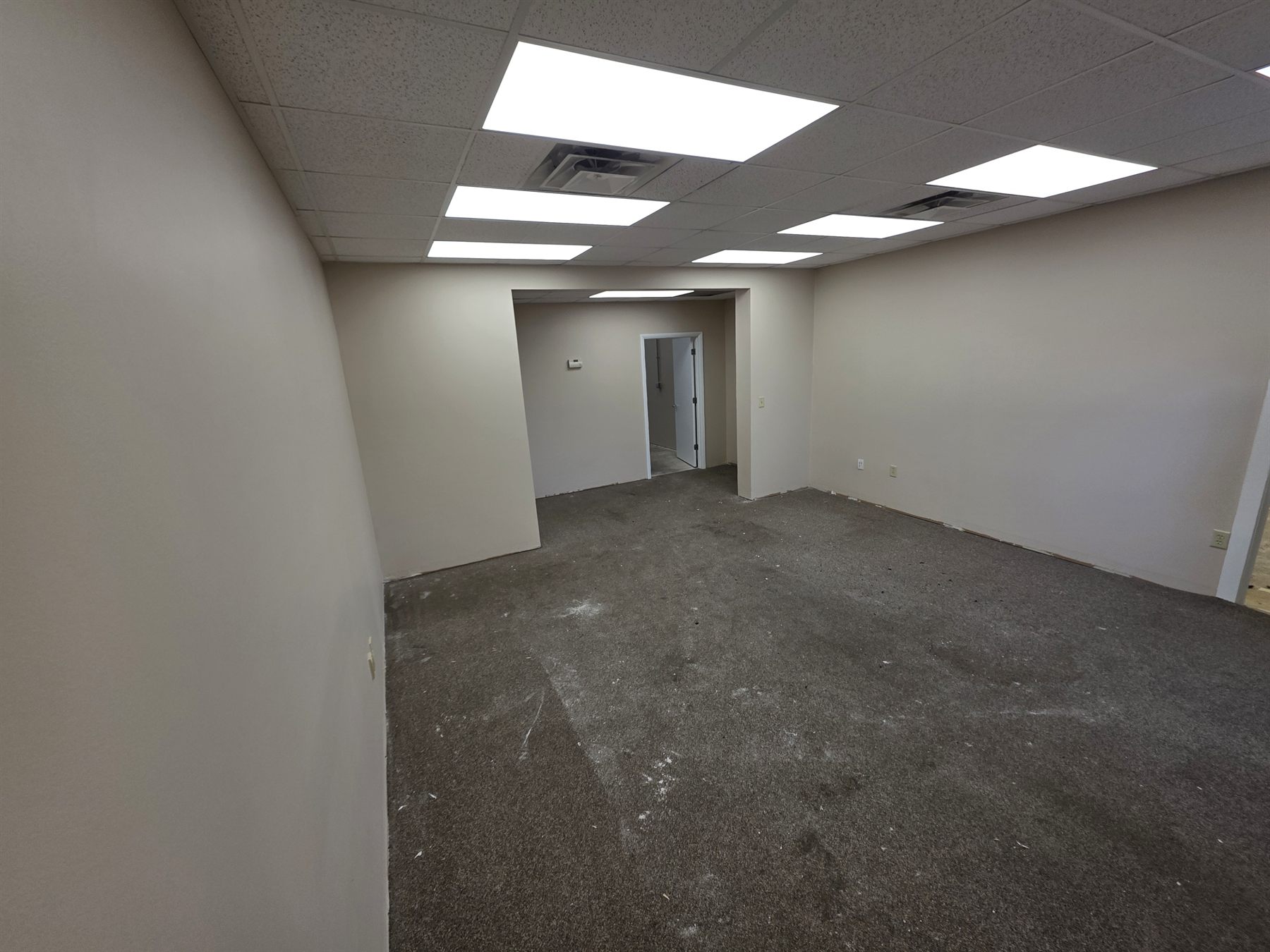 Main commercial space after carpet and wall base removal