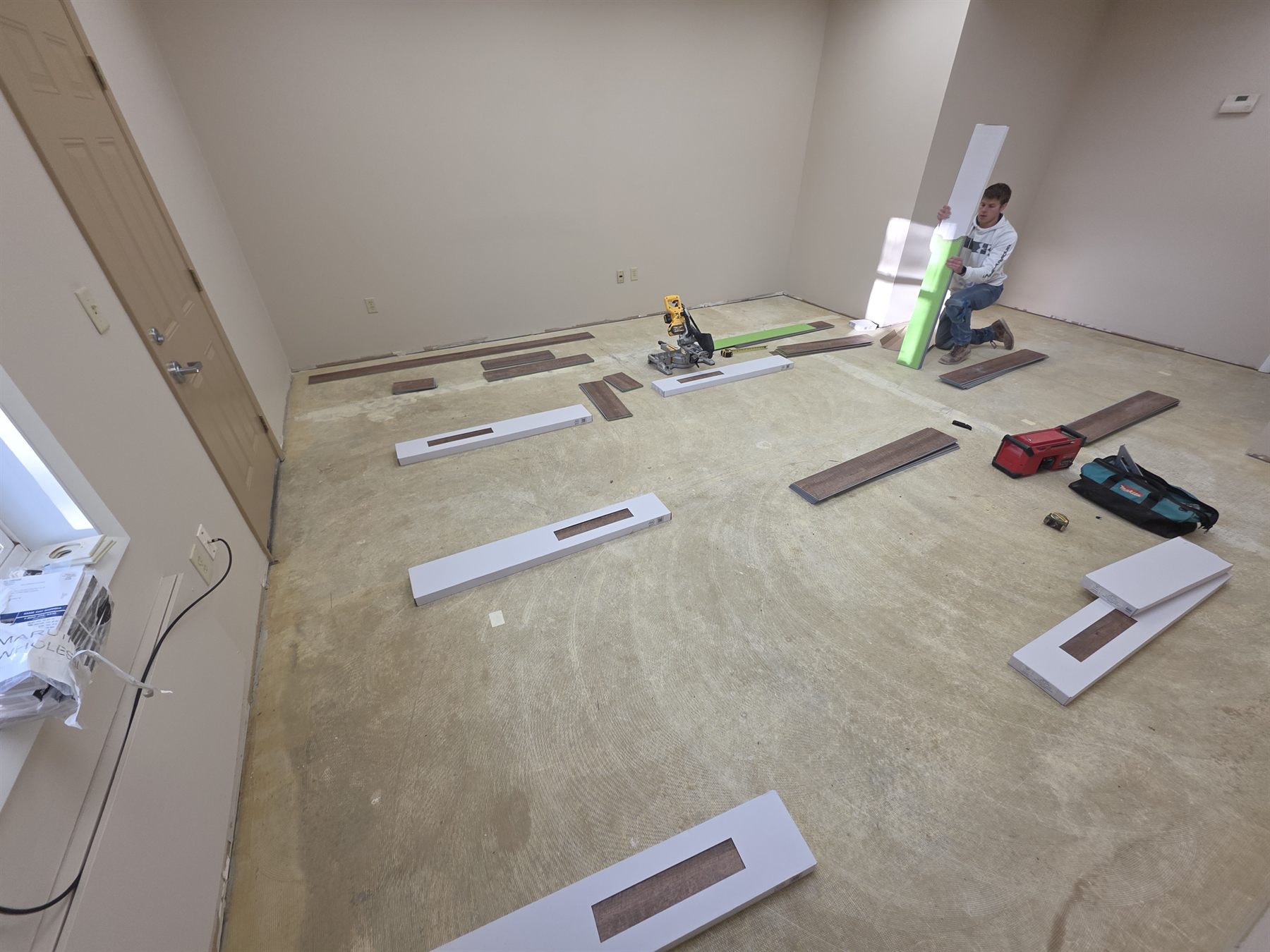 Luxury vinyl plank installation underway