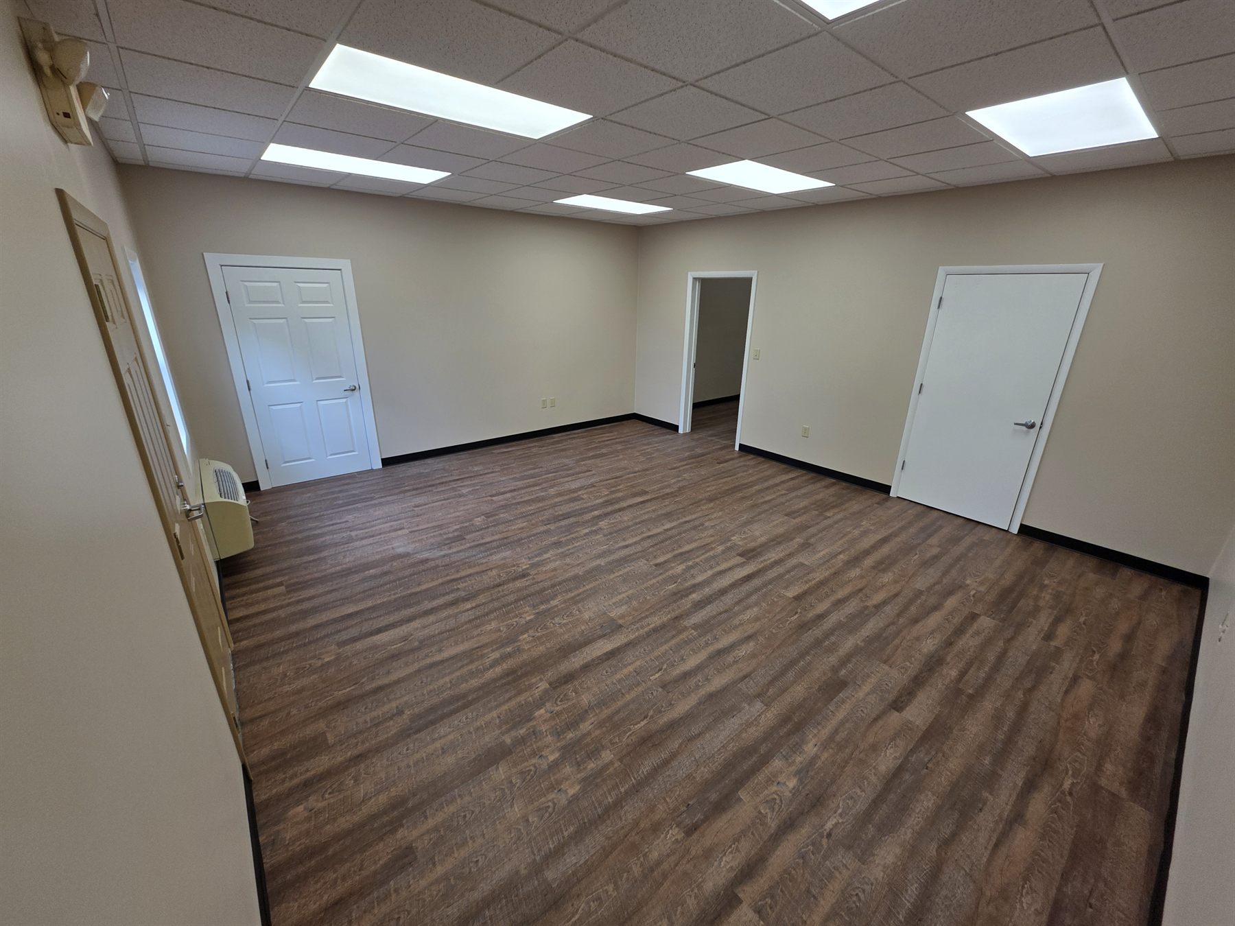 Finished room with wood-look LVP and black wall base