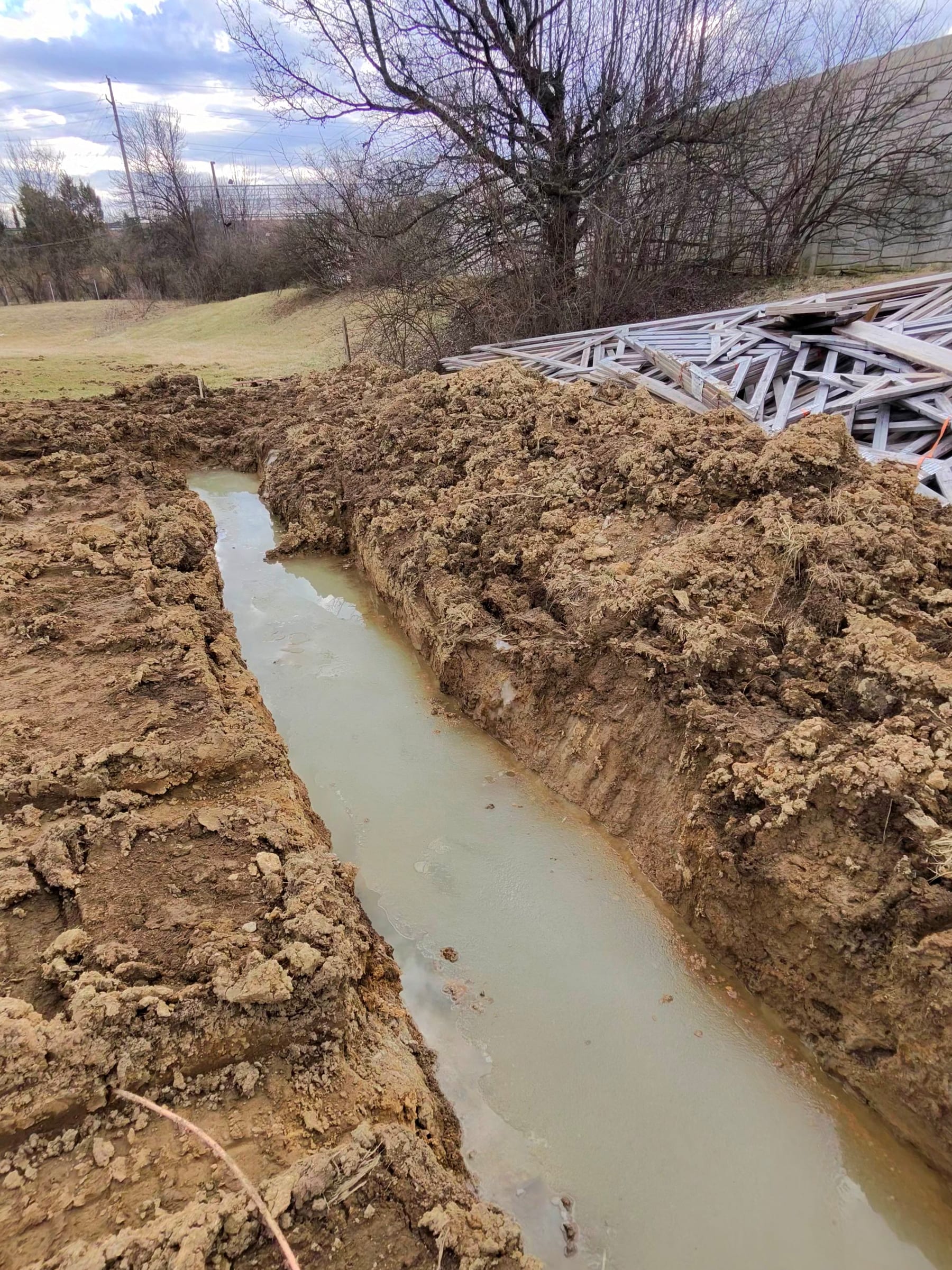 Long footer trench with standing water during excavation