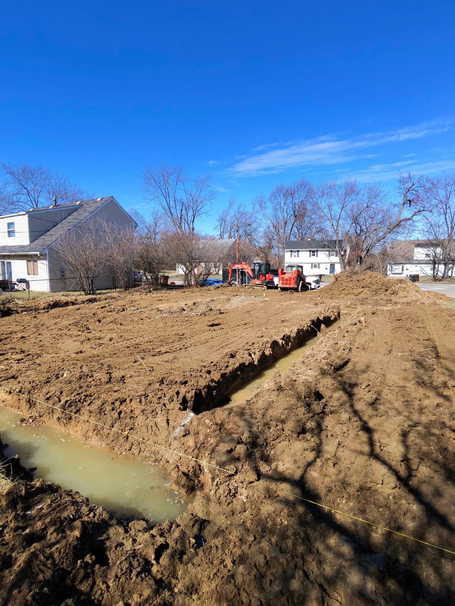 Wide view of the excavated footer lines and layout strings