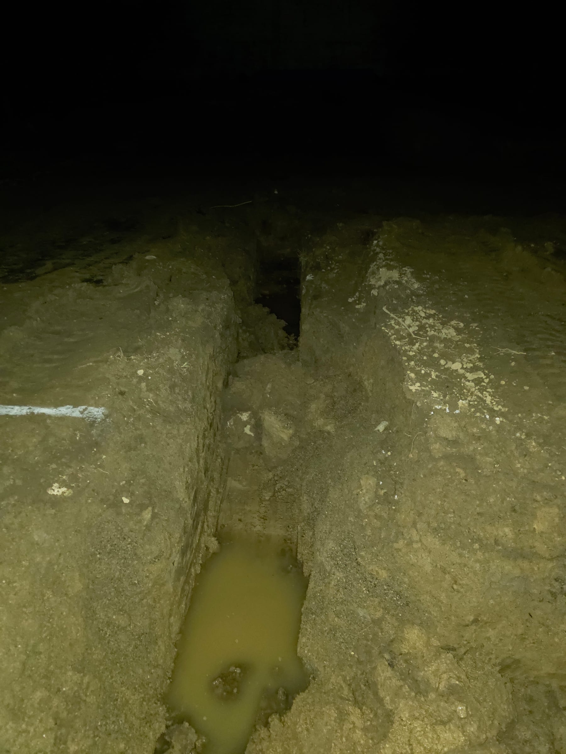 Freshly excavated footer trench at night