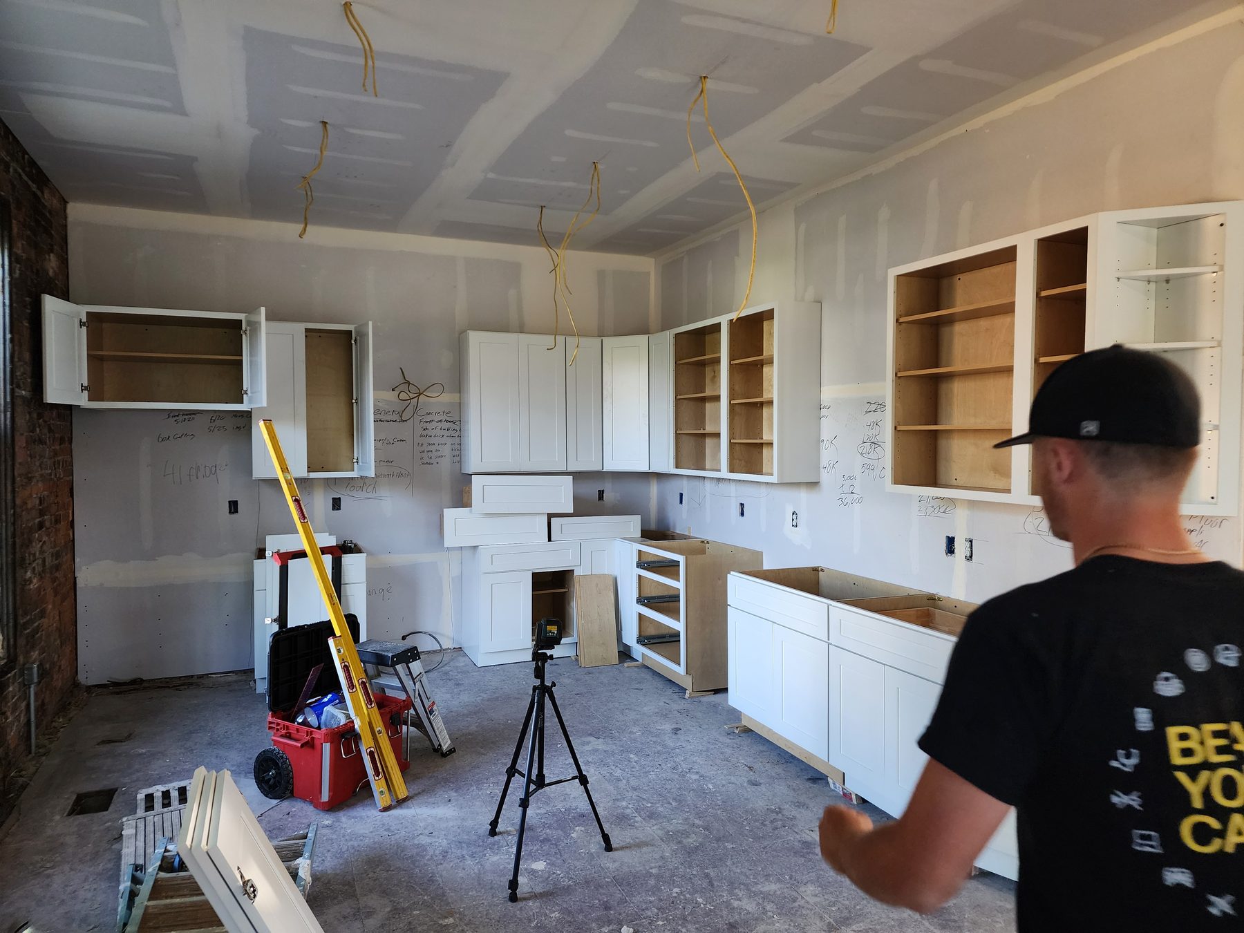 Cabinet doors and base cabinets being fitted during installation
