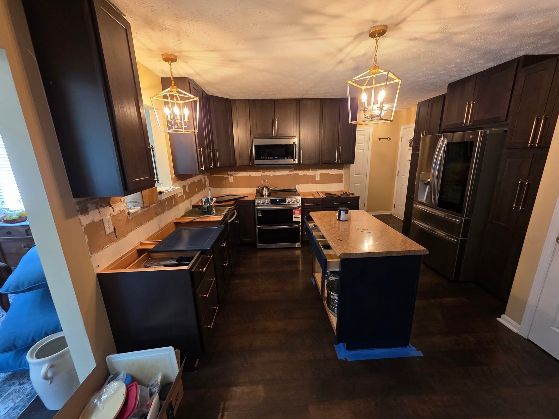 Dark cabinetry and refrigerator storage wall taking shape