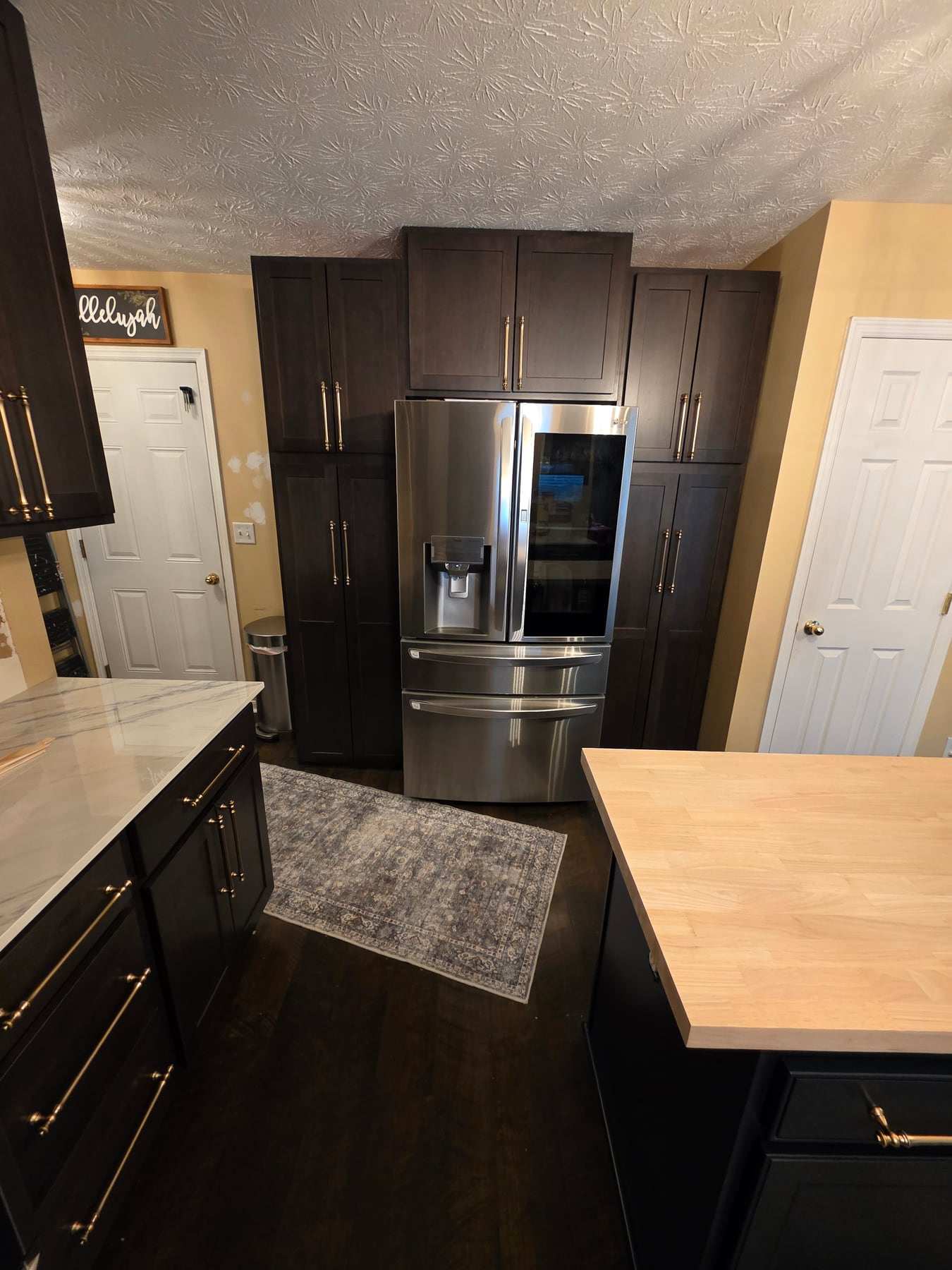 Full-height cabinetry surrounding the refrigerator