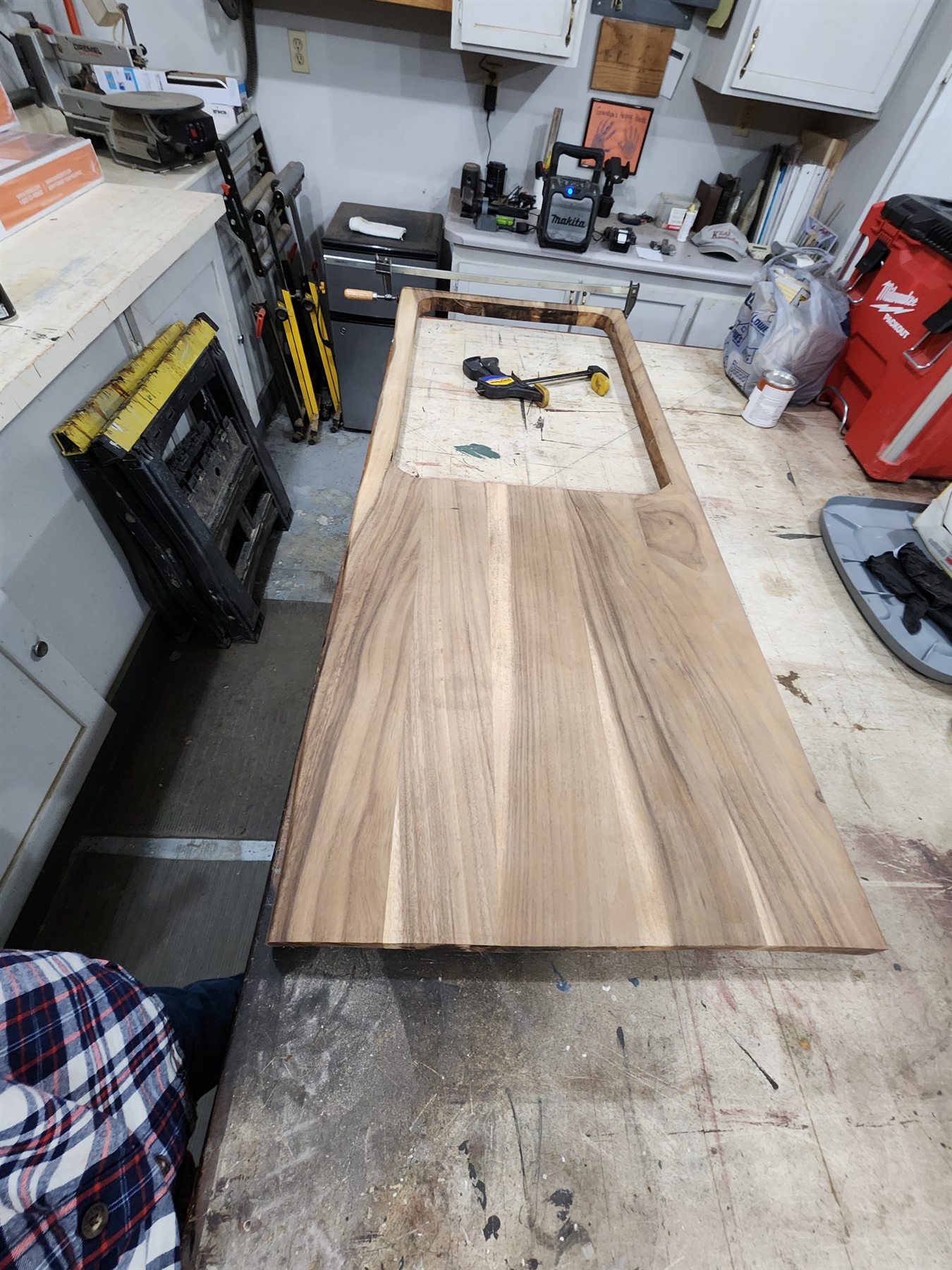 Live-edge countertop slab laid out on a workbench for rebuilding