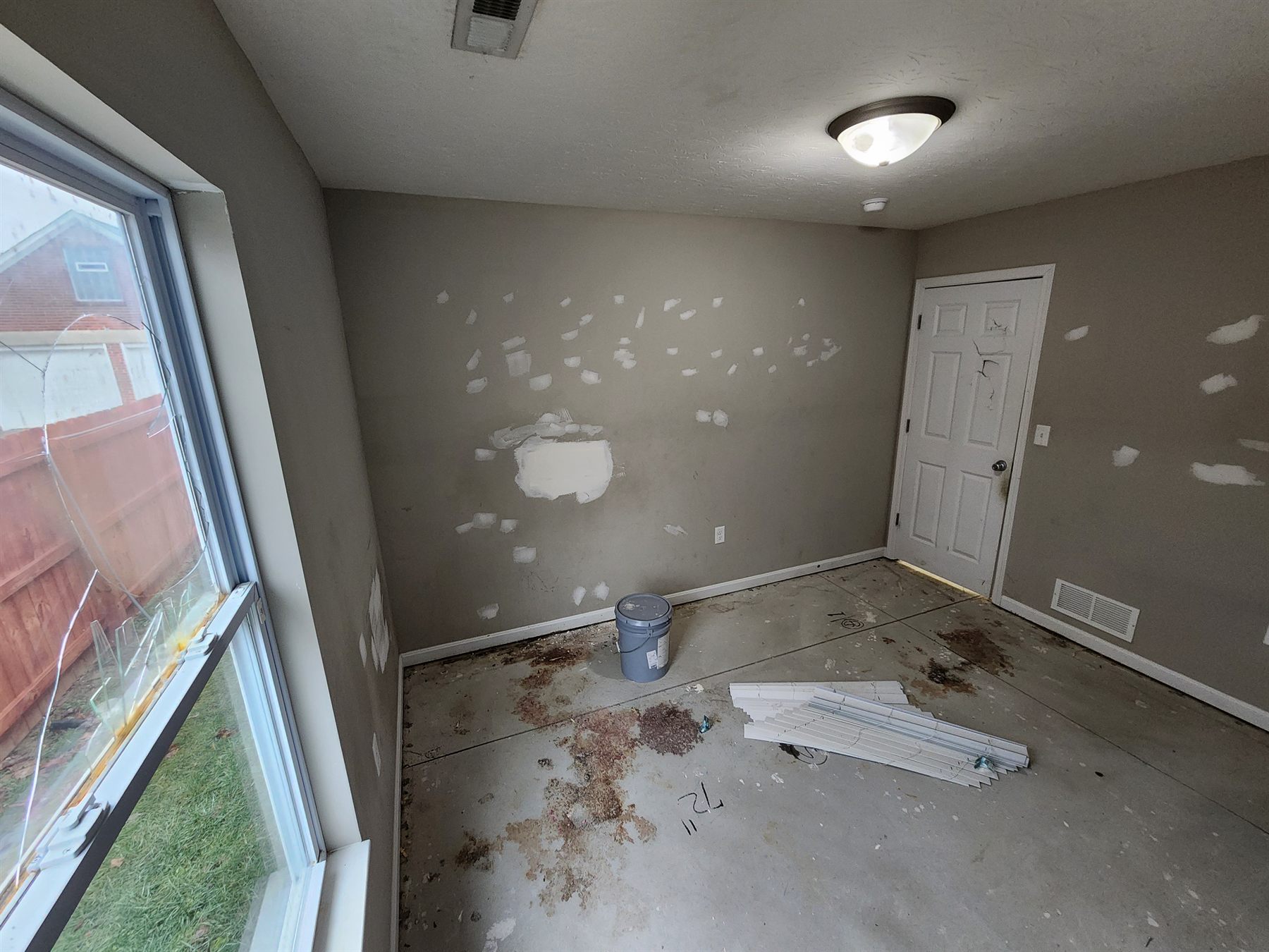 Drywall patches across a bedroom wall