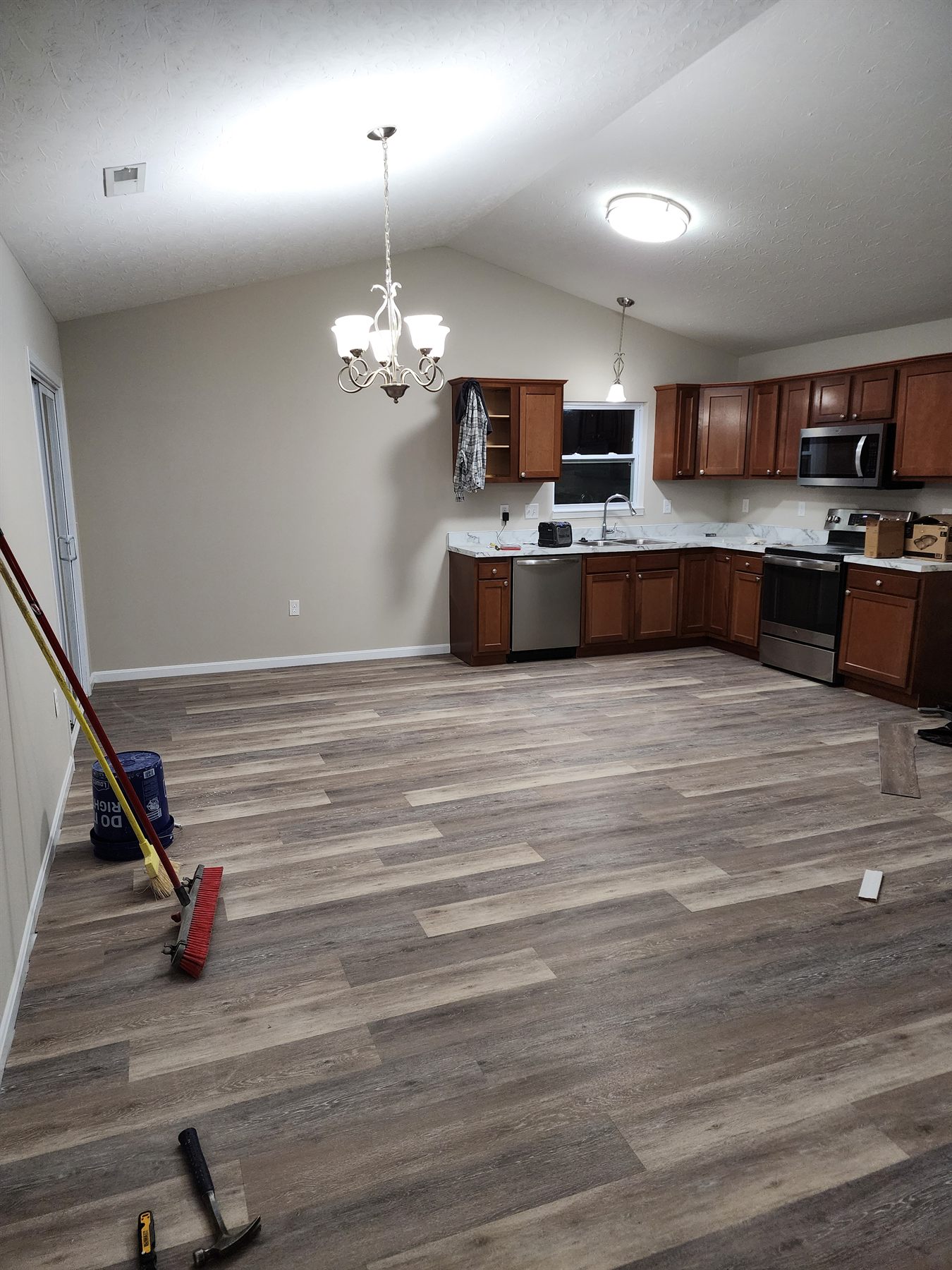 New LVP flooring nearing completion in the kitchen
