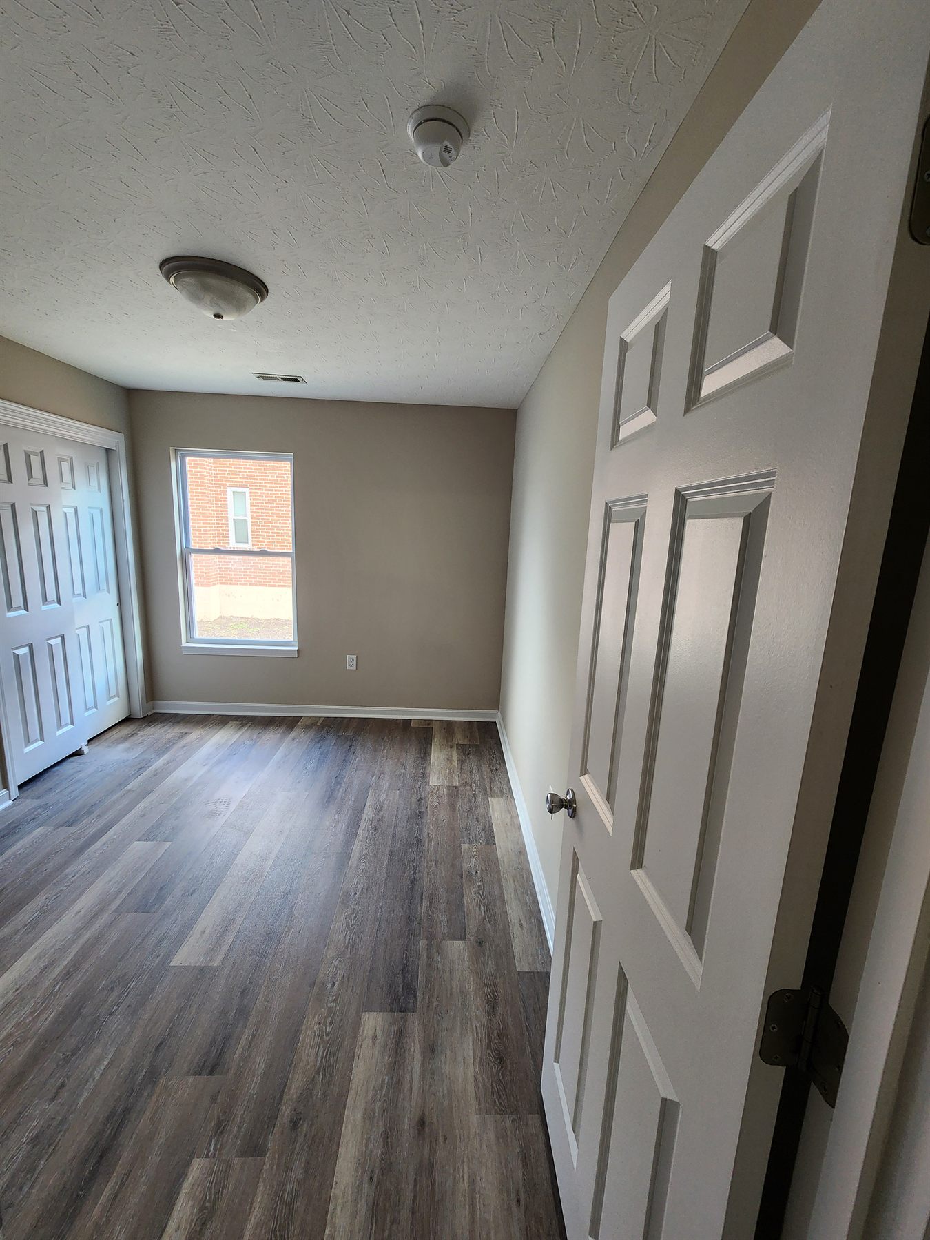 Another completed bedroom with painted walls and new flooring