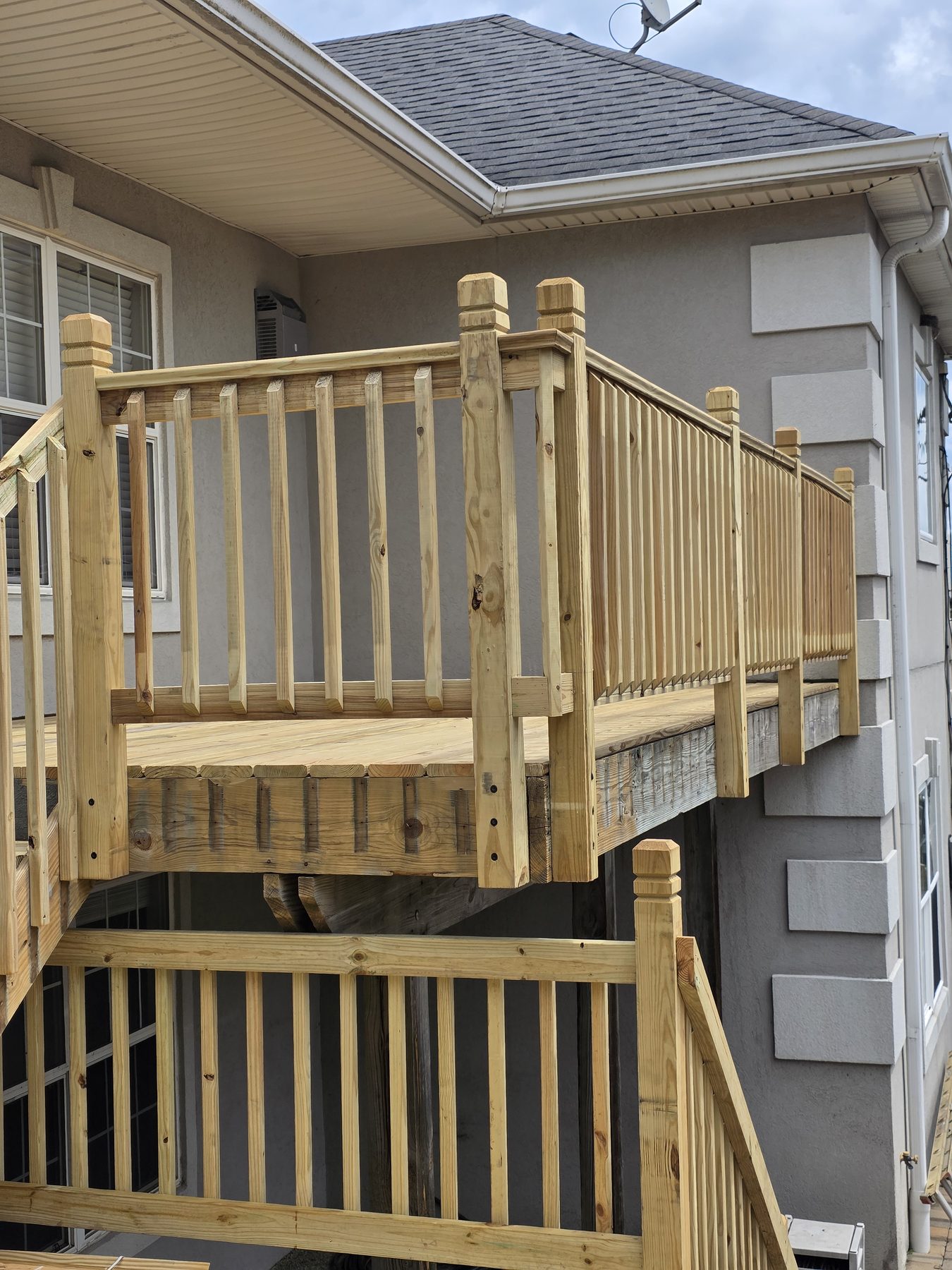 Finished upper deck and railing beside the home